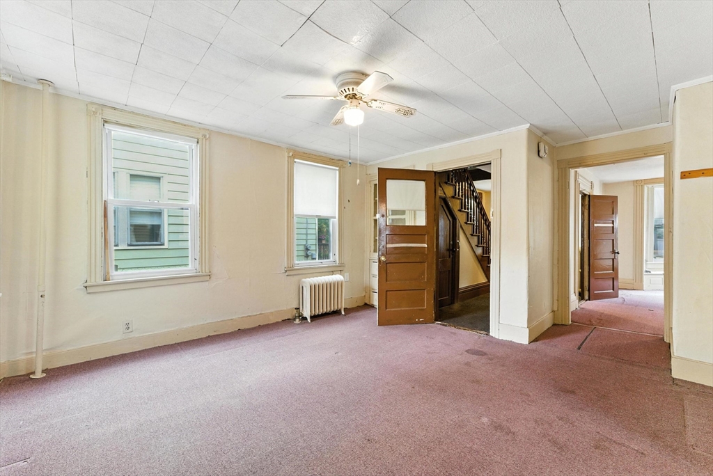 112 Grape Street Chicopee, MA 01013 - Photo 8 of 42 a view of a livingroom with a ceiling fan and window