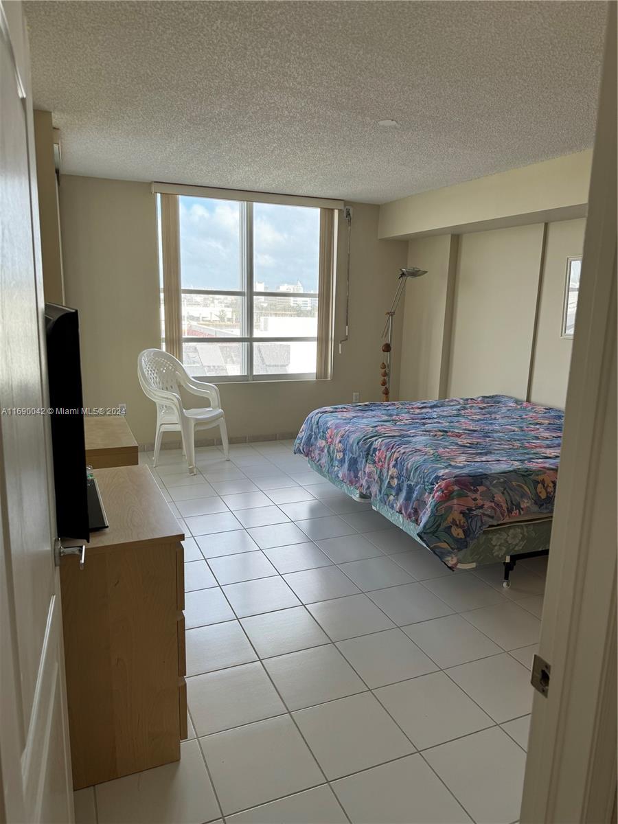 Sunset Harbour Miami Beach, FL 33139 - Photo 23 of 47 a bedroom with a bed and a television in it