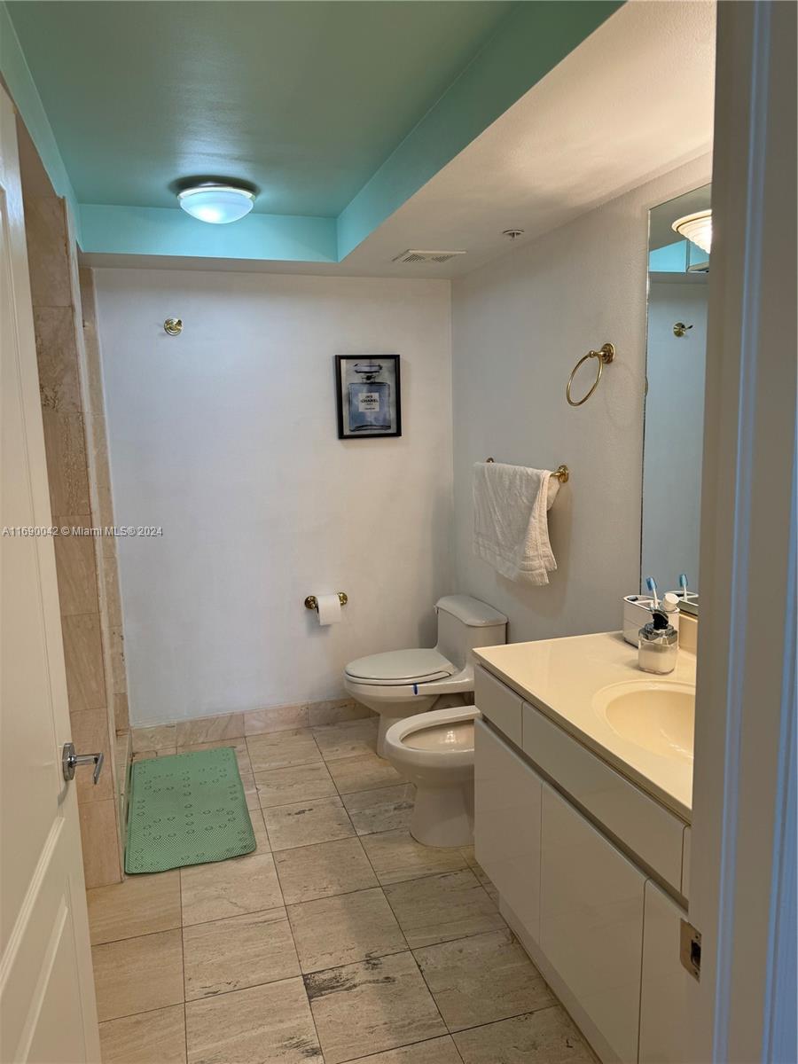 Sunset Harbour Miami Beach, FL 33139 - Photo 31 of 47 a bathroom with a granite countertop sink a toilet and a mirror