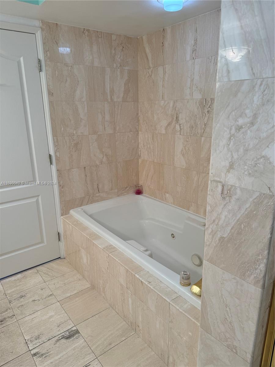 Sunset Harbour Miami Beach, FL 33139 - Photo 32 of 47 a bath tub sitting next to a white sink and vanity