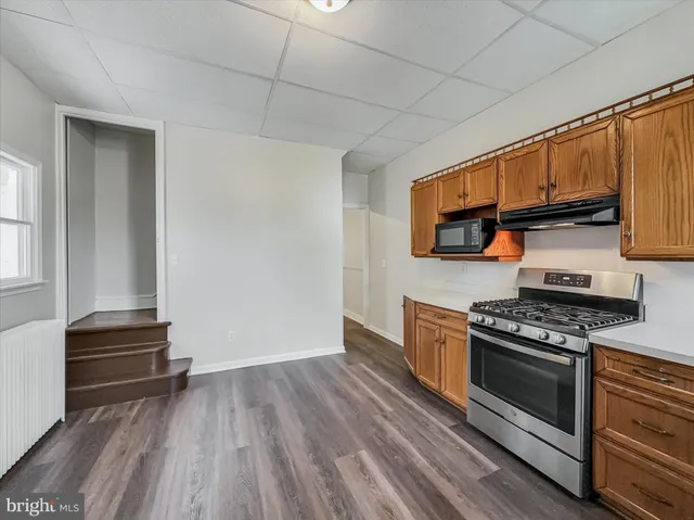 a kitchen with wooden floors and a stove top oven