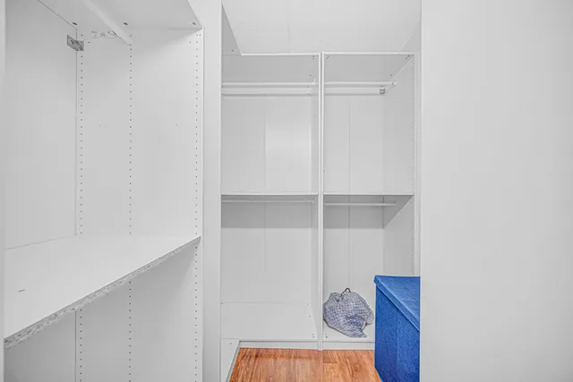 a view of a room with wooden floor