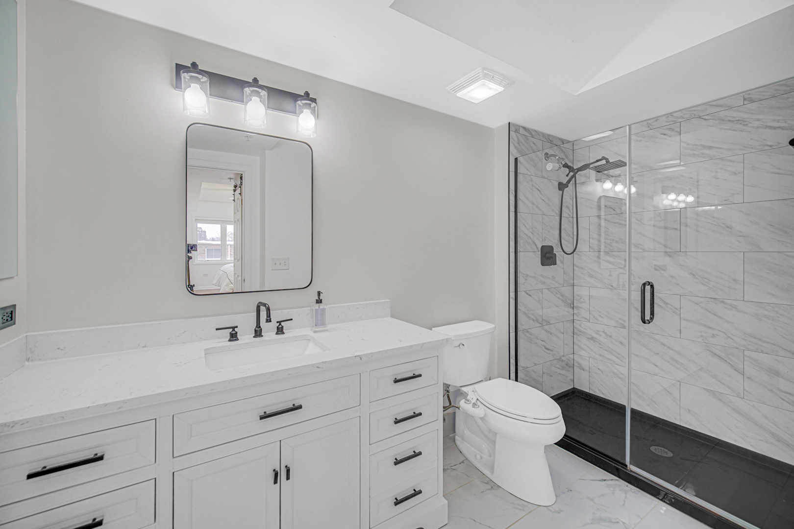 476 Alles Street, Unit 406 Des Plaines, IL 60016 - Photo 16 of 25 a bathroom with a double vanity sink toilet mirror and shower