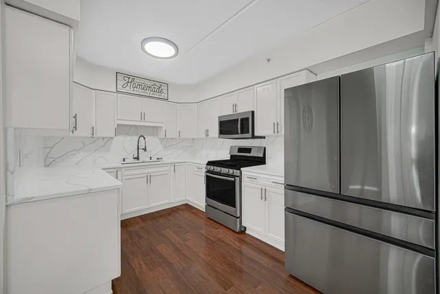 a kitchen with a refrigerator stove and sink