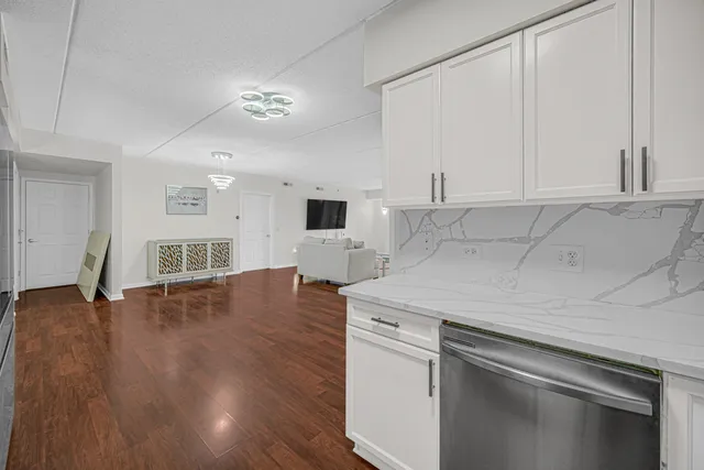a kitchen with a sink cabinets and wooden floor
