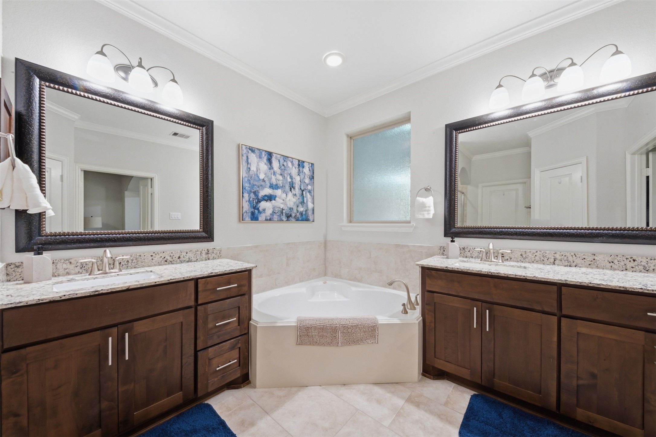 706 Water Street Webster, TX 77598 - Photo 14 of 23 Designed for comfort, the primary bath features dual sinks, a soaking tub, and separate shower. Direct access from bathroom to spacious walk-in closet, keeps everything organized and easily accessible.