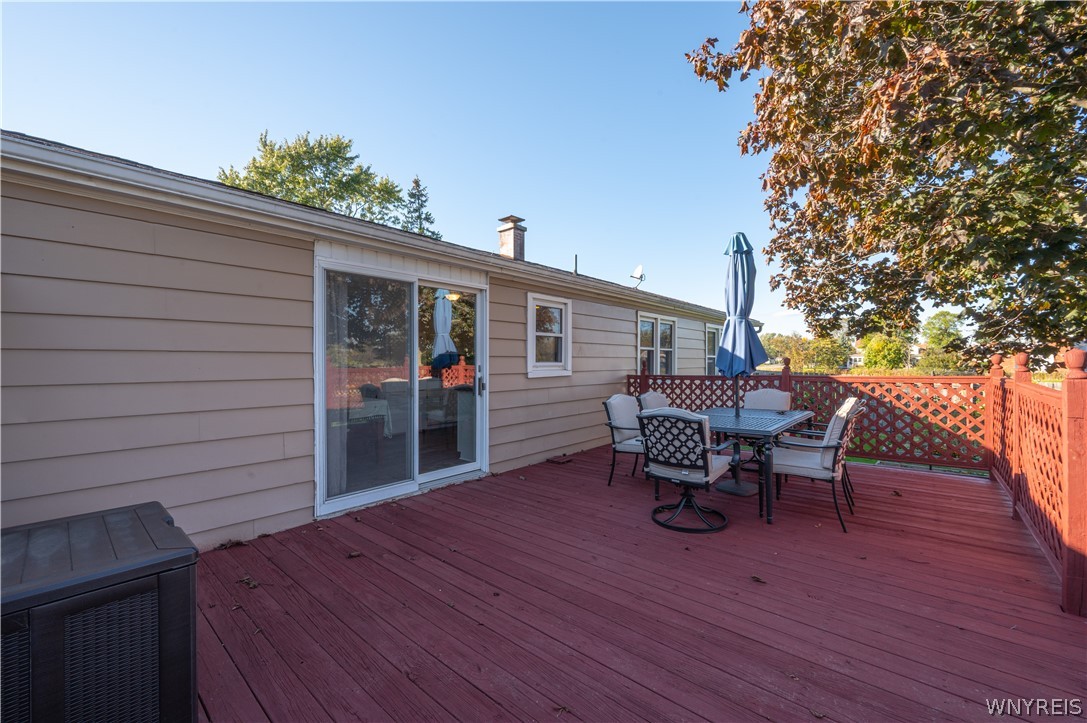 6463 Ward Road Sanborn, NY 14132 - Photo 42 of 49 An elevated wood deck with perimeter railing steps out from the sliding glass doors.