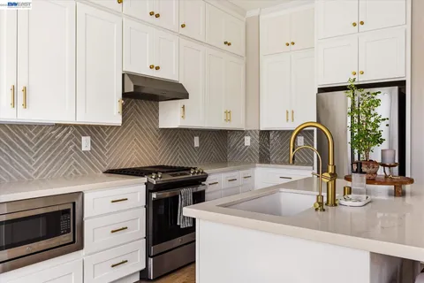 a kitchen with granite countertop a stove and a sink