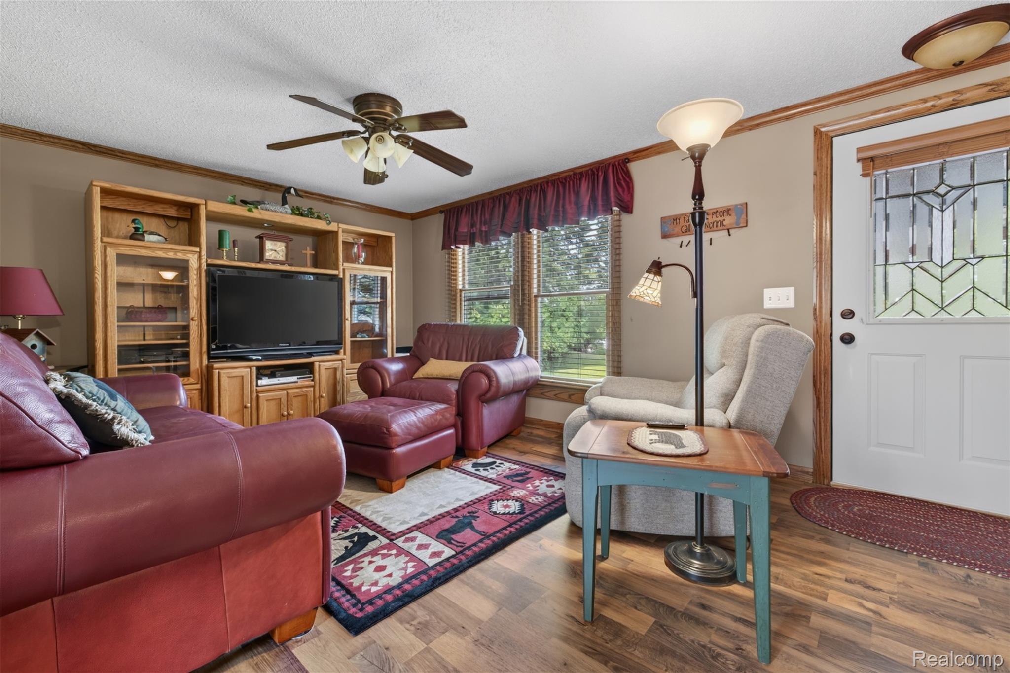 5977 Anglers Road Ortonville, MI 48462 - Photo 4 of 63 Living area with wood-finish flooring, a ceiling fan, and a large window