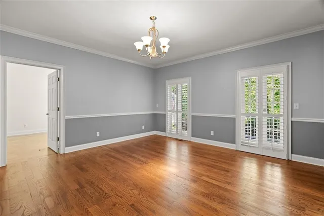 a view of a kitchen with wooden floor and a kitchen