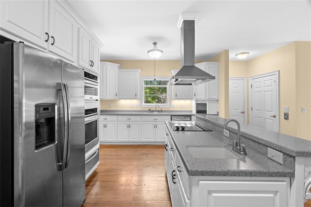 2058 Sewanee Court Villa Rica, GA 30180 - Photo 19 of 91 a kitchen with stainless steel appliances granite countertop a sink stove and refrigerator