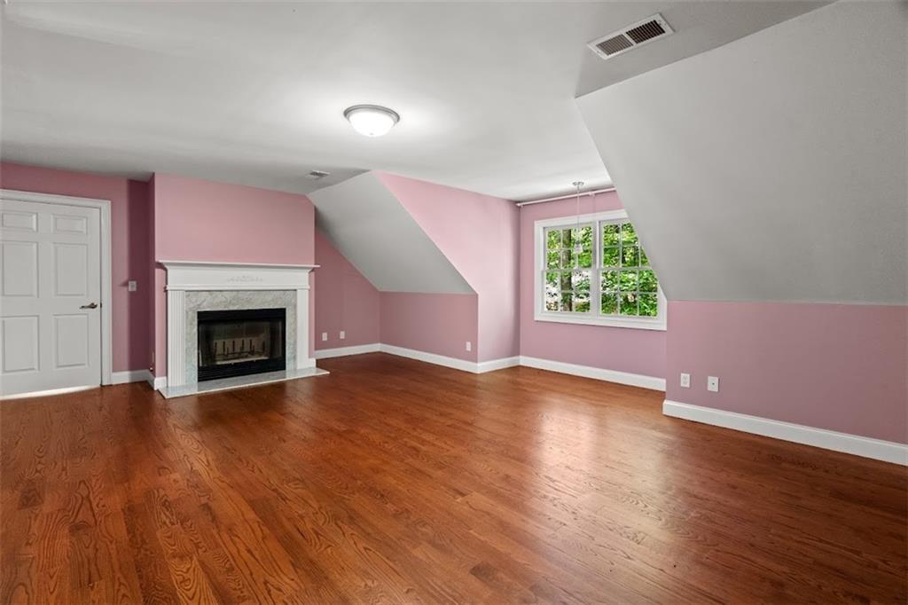 2058 Sewanee Court Villa Rica, GA 30180 - Photo 40 of 91 an empty room with wooden floor a fireplace and windows