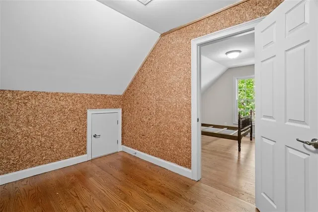 an aerial view of a house with a yard and large trees