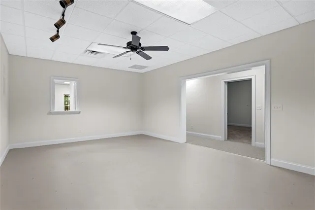a view of a house with a yard covered with snow in the background