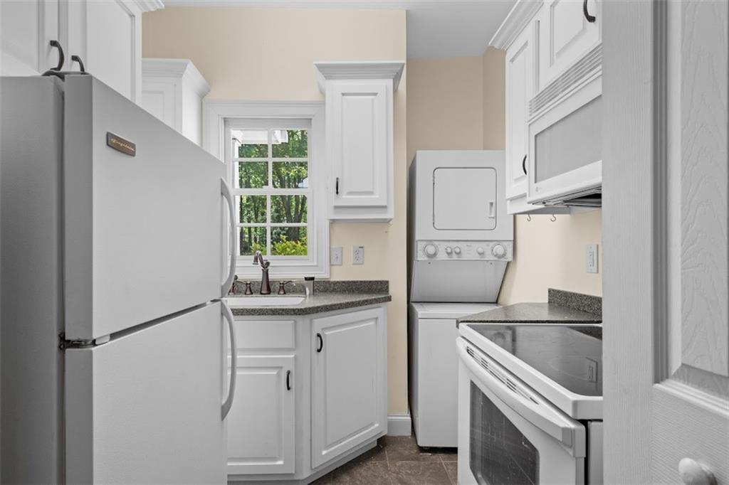 2058 Sewanee Court Villa Rica, GA 30180 - Photo 66 of 91 a kitchen with stainless steel appliances a refrigerator sink and cabinets
