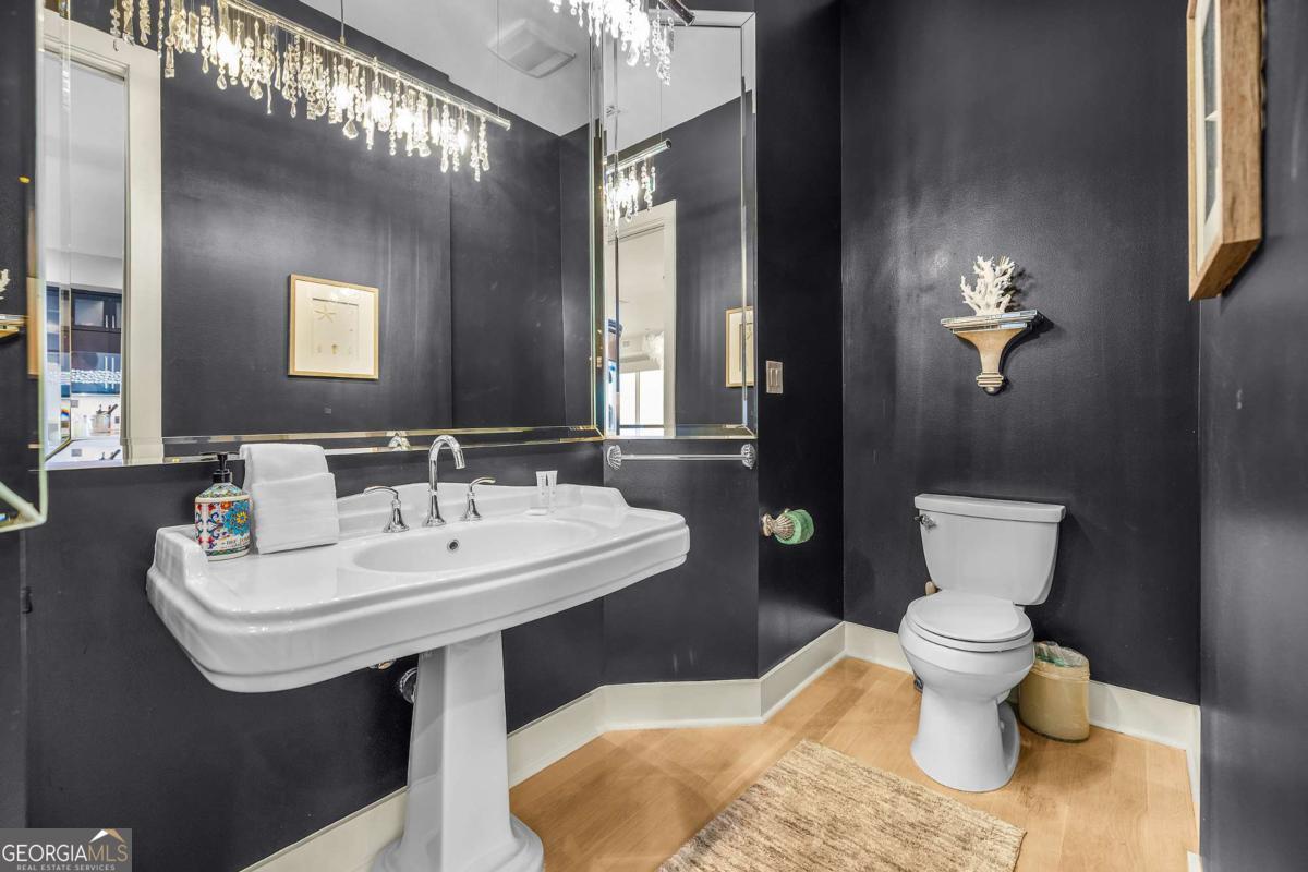 8 18th Street Tybee Island, GA 31328 - Photo 39 of 50 a bathroom with a toilet sink and mirror