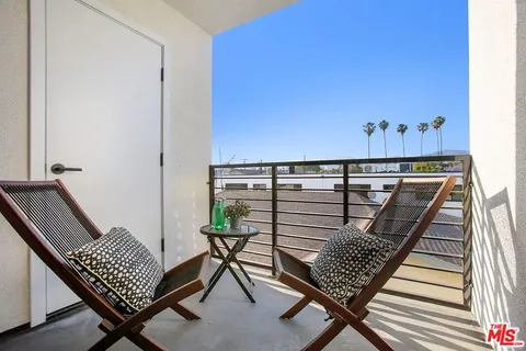 a view of balcony with wooden floor