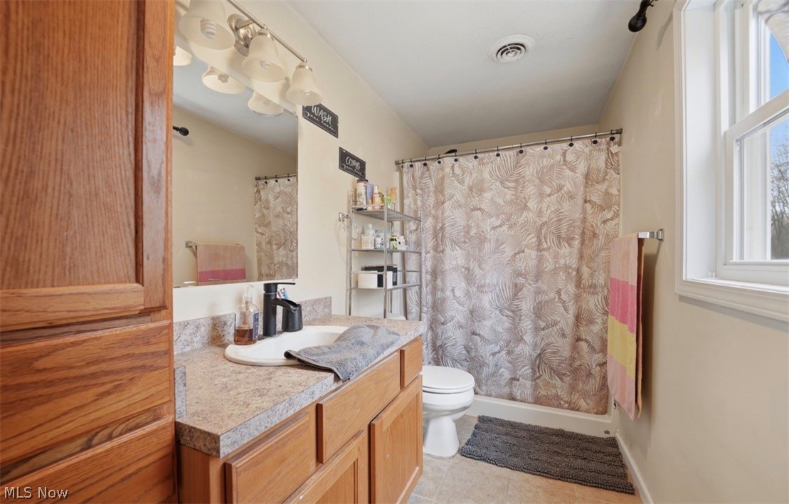 4132 Benetka Road Ashtabula, OH 44004 - Photo 14 of 20 Full bath featuring curtained shower, vanity, and light tile patterned flooring