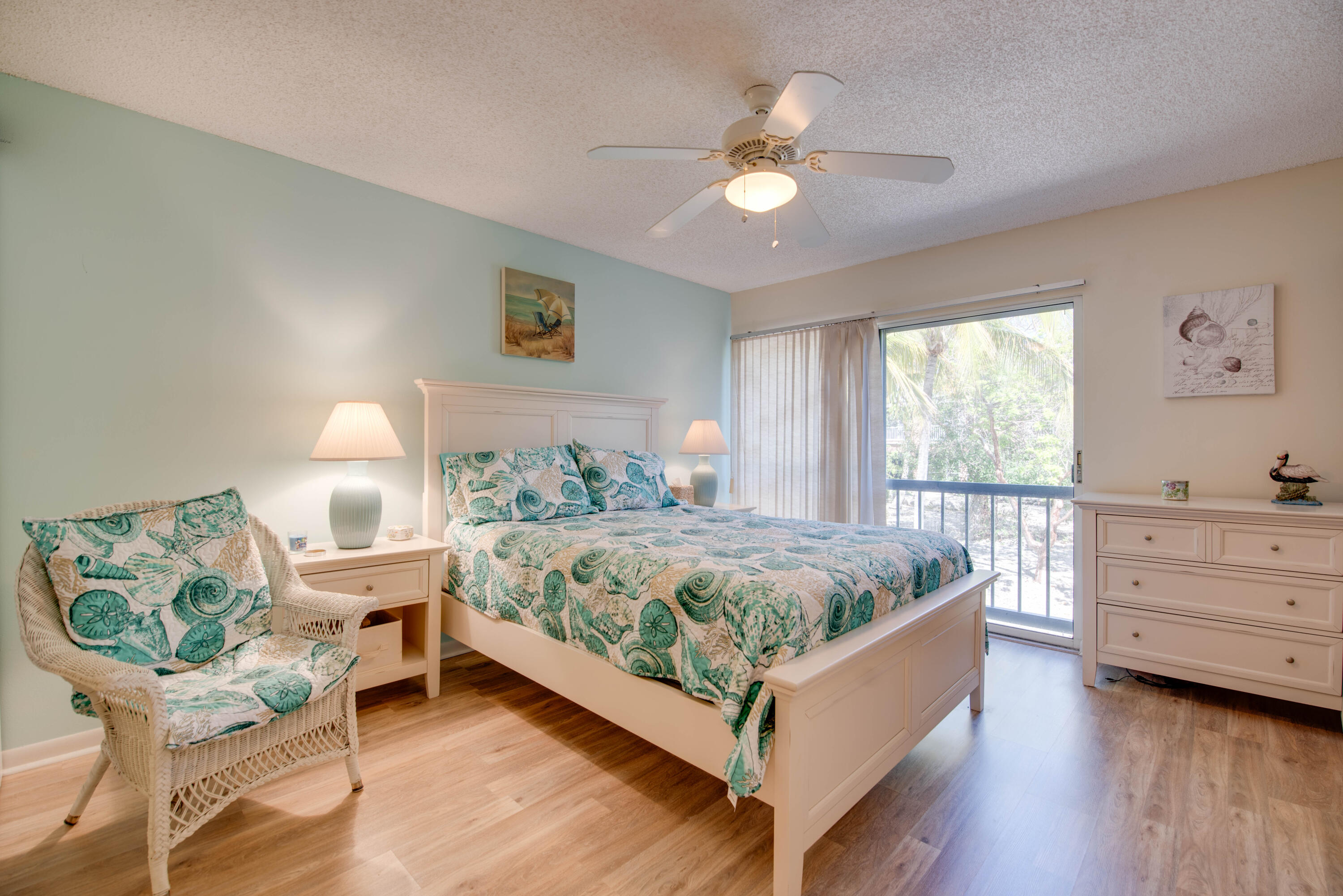 9867 Leeward Avenue Key Largo, FL 33037 - Photo 12 of 32 a bedroom with a bed and a chandelier