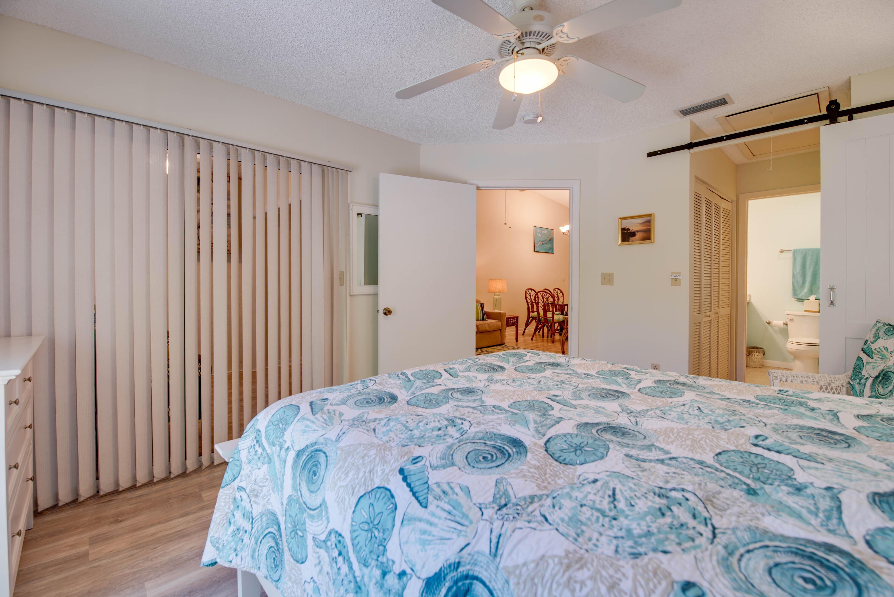 9867 Leeward Avenue Key Largo, FL 33037 - Photo 13 of 32 a bedroom with a bed and a chandelier