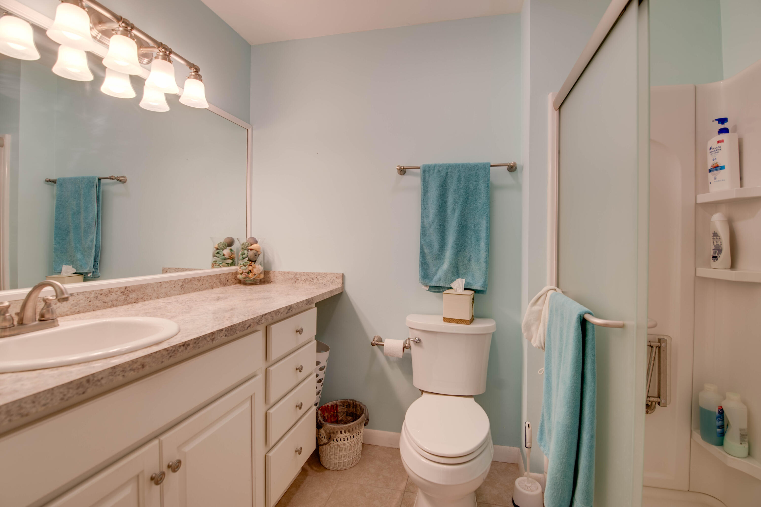 9867 Leeward Avenue Key Largo, FL 33037 - Photo 14 of 32 a bathroom with a granite countertop toilet sink and mirror