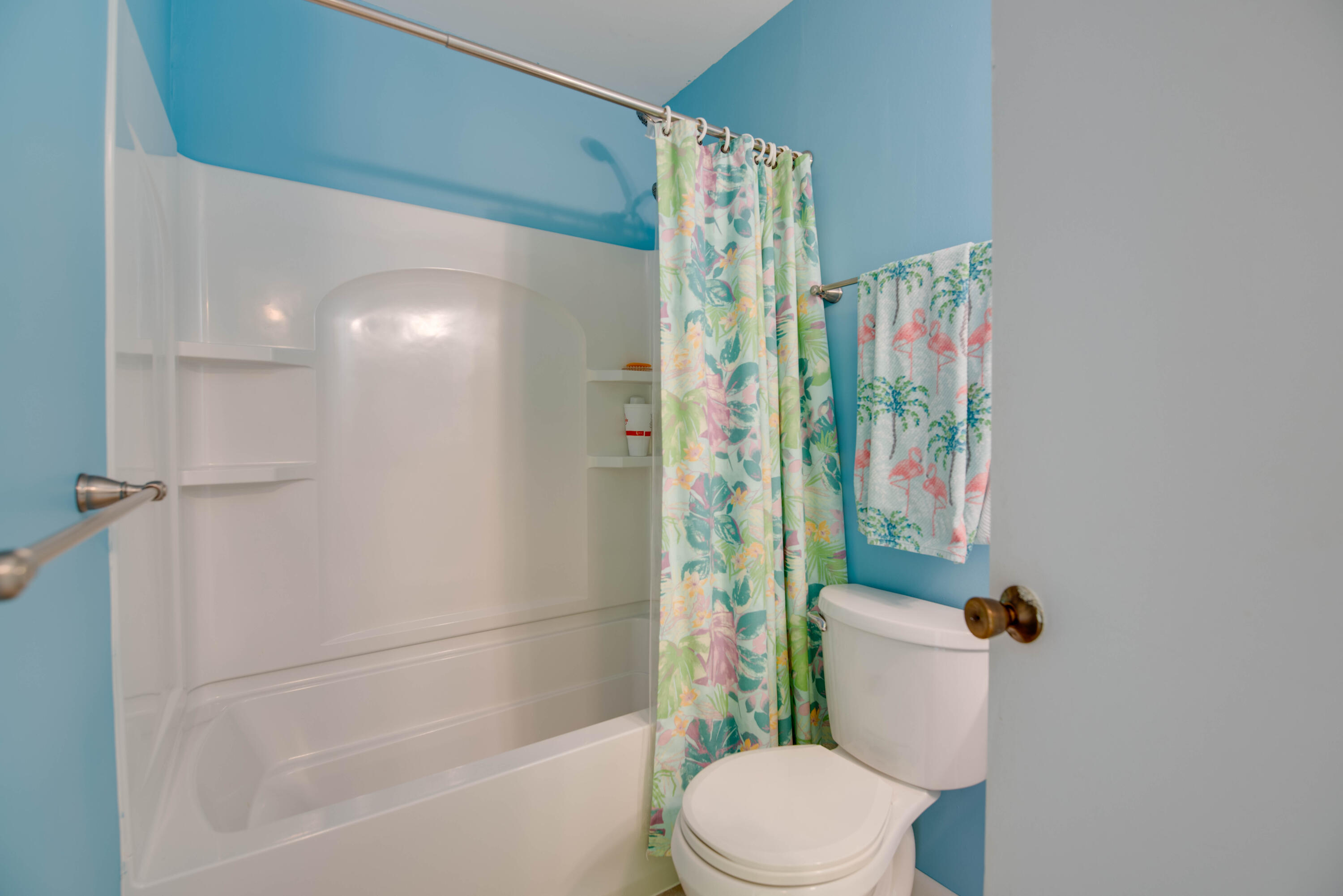 9867 Leeward Avenue Key Largo, FL 33037 - Photo 17 of 32 a white toilet sitting next to a bathroom sink