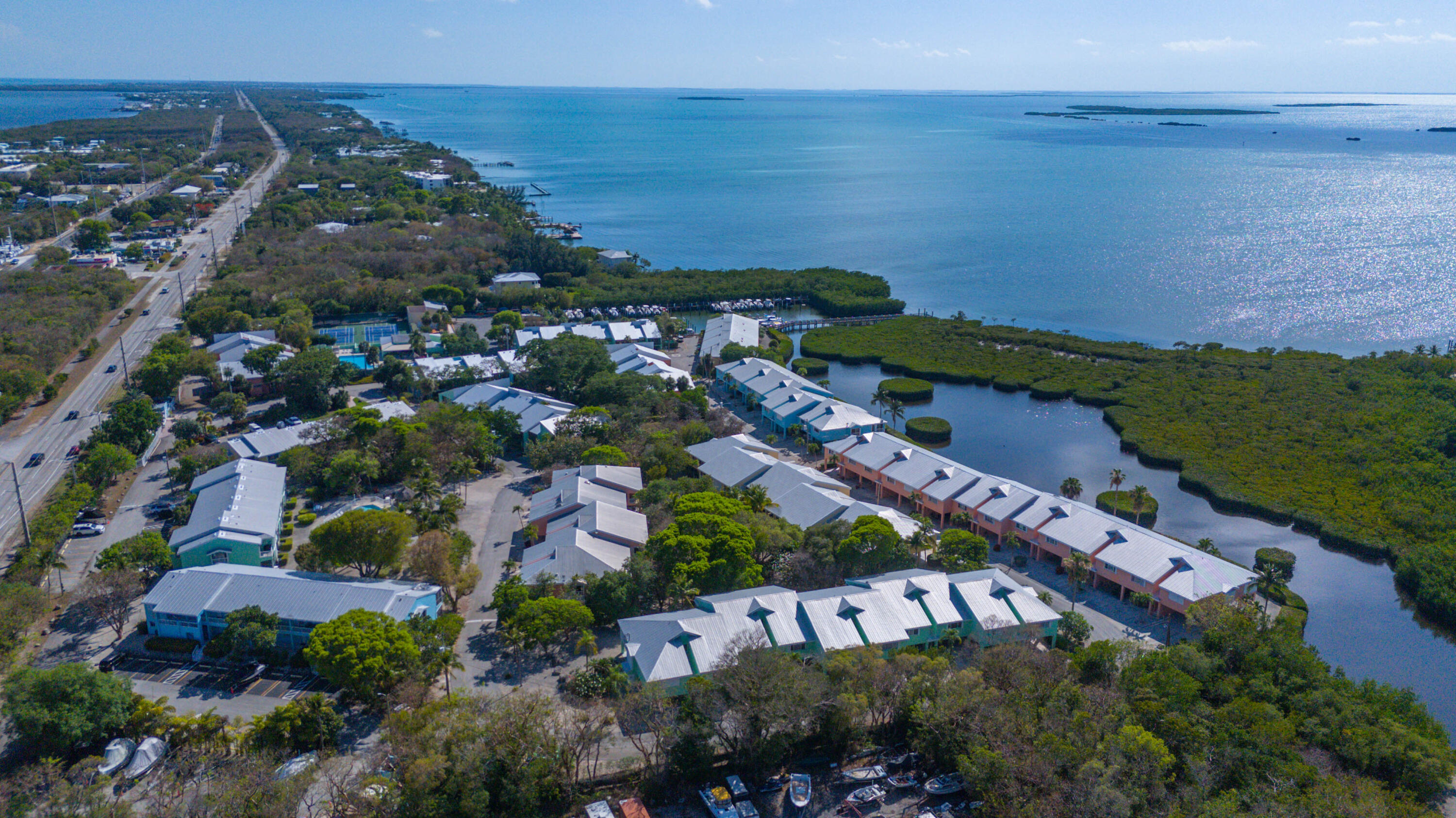 9867 Leeward Avenue Key Largo, FL 33037 - Photo 30 of 32 an aerial view of a city with lots of residential buildings ocean and mountain view in back