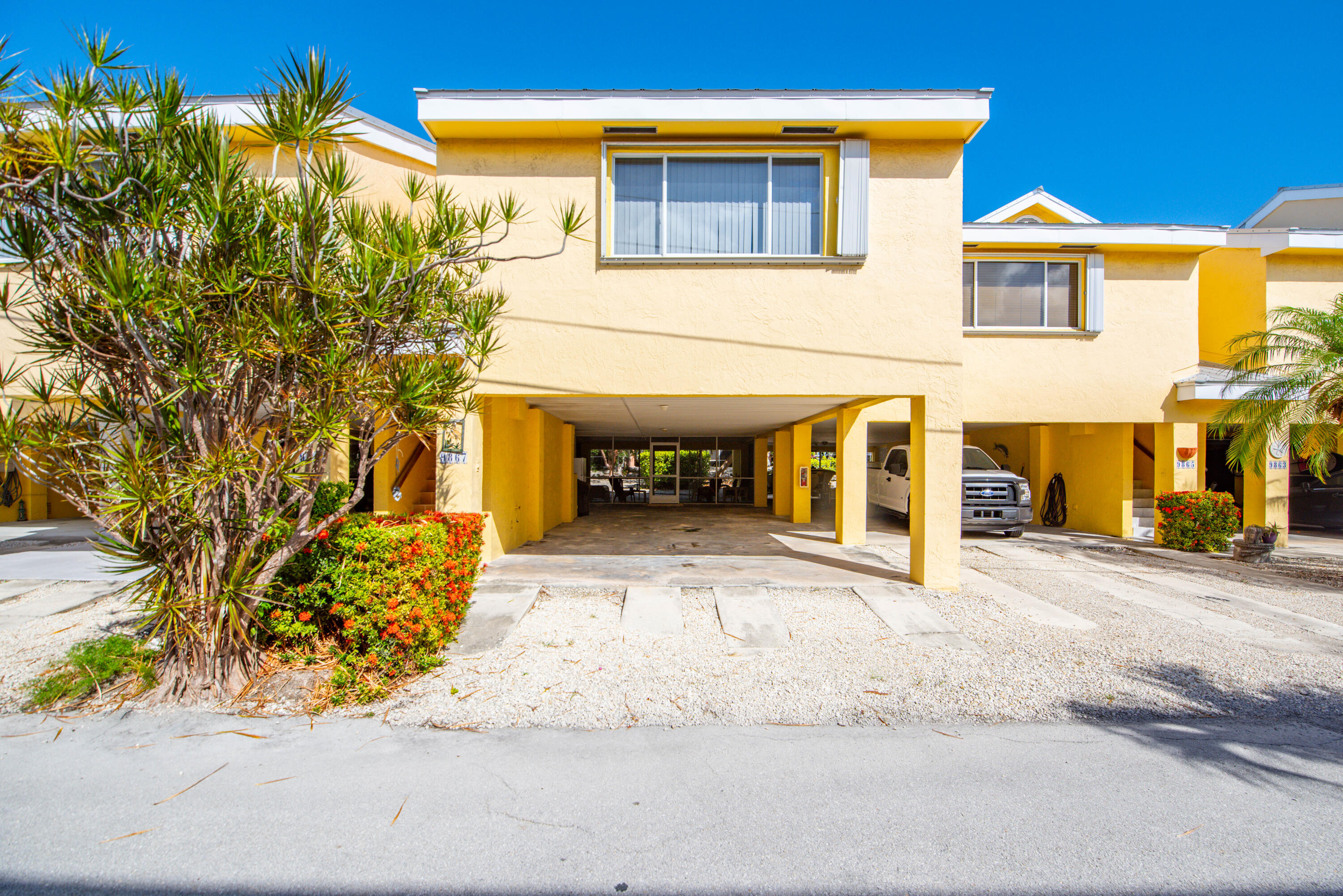 9867 Leeward Avenue Key Largo, FL 33037 - Photo 4 of 32 front view of a house with a yard