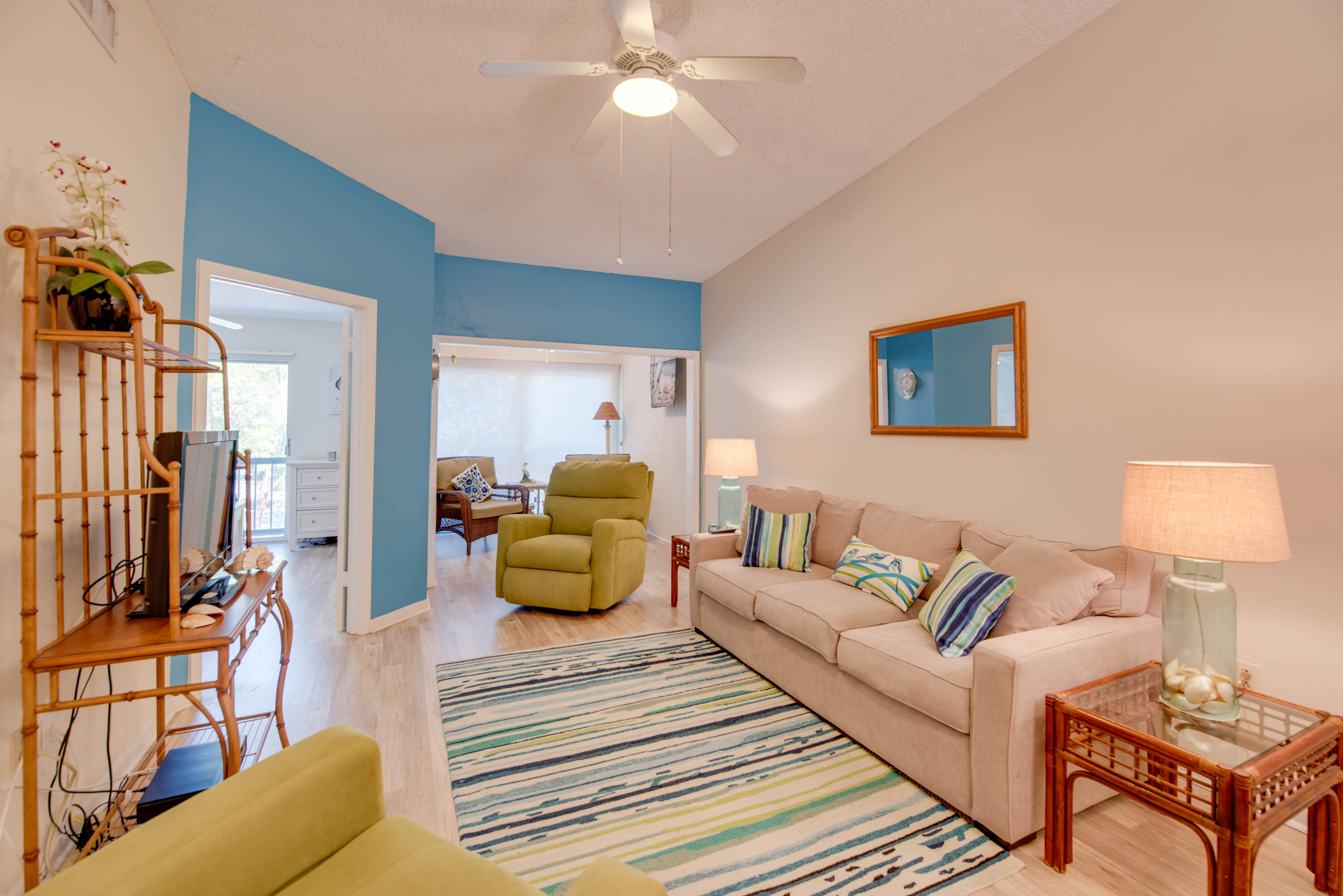 9867 Leeward Avenue Key Largo, FL 33037 - Photo 6 of 32 a spacious bedroom with a bed a couch and a chandelier