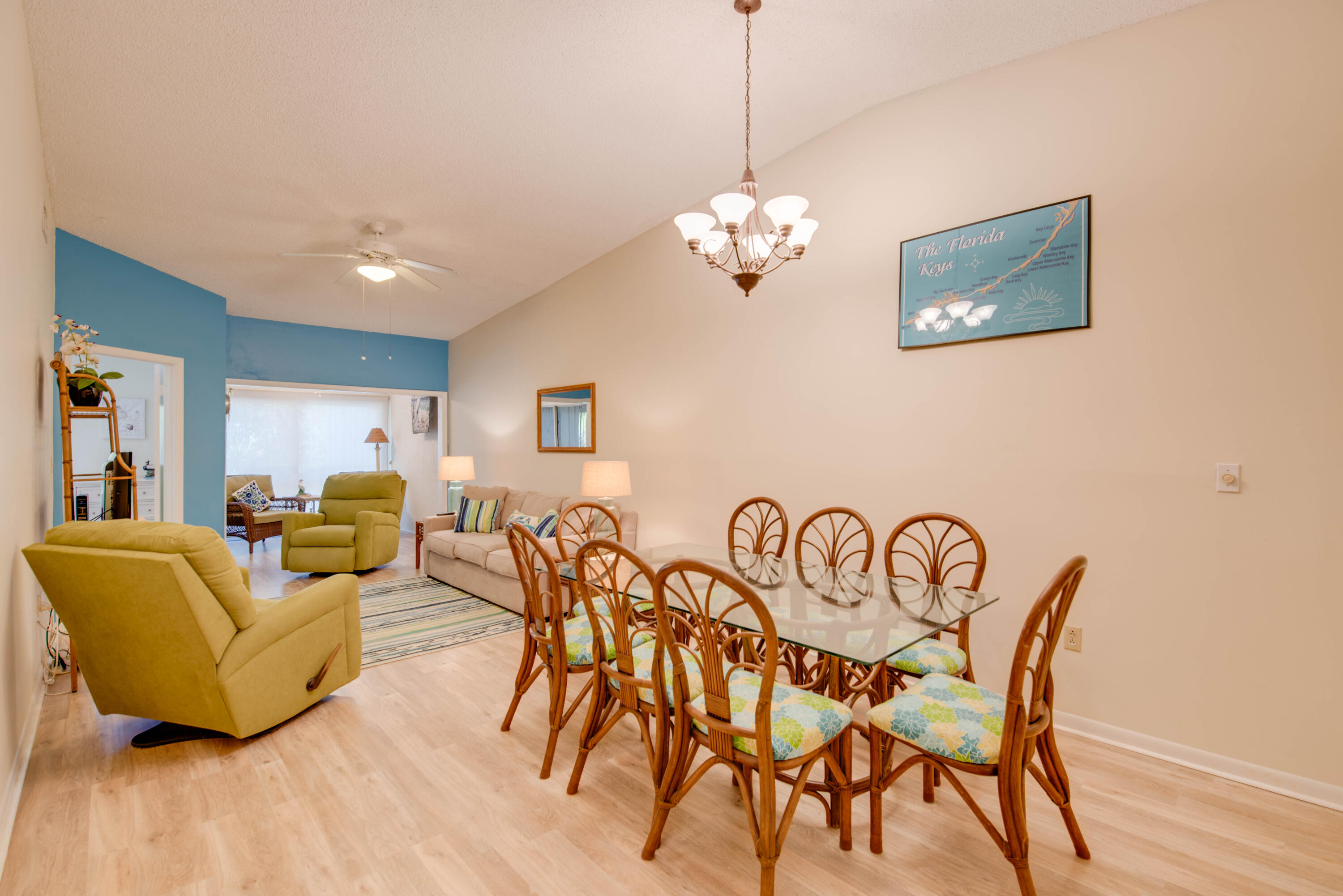 9867 Leeward Avenue Key Largo, FL 33037 - Photo 7 of 32 a view of a dining room with furniture wooden floor and chandelier