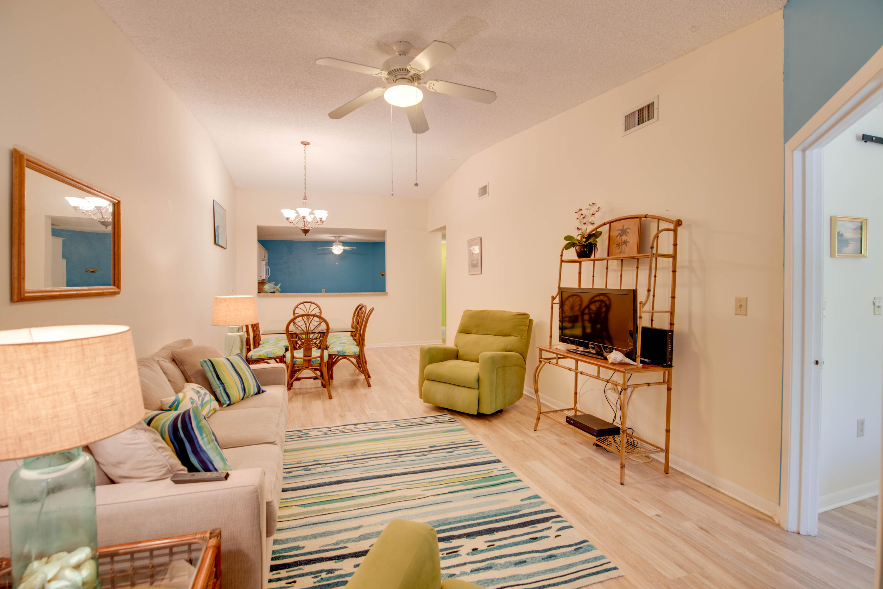 9867 Leeward Avenue Key Largo, FL 33037 - Photo 8 of 32 a living room with furniture a flat screen tv and a chandelier