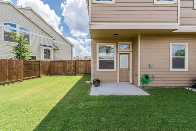 a view of a house with a backyard
