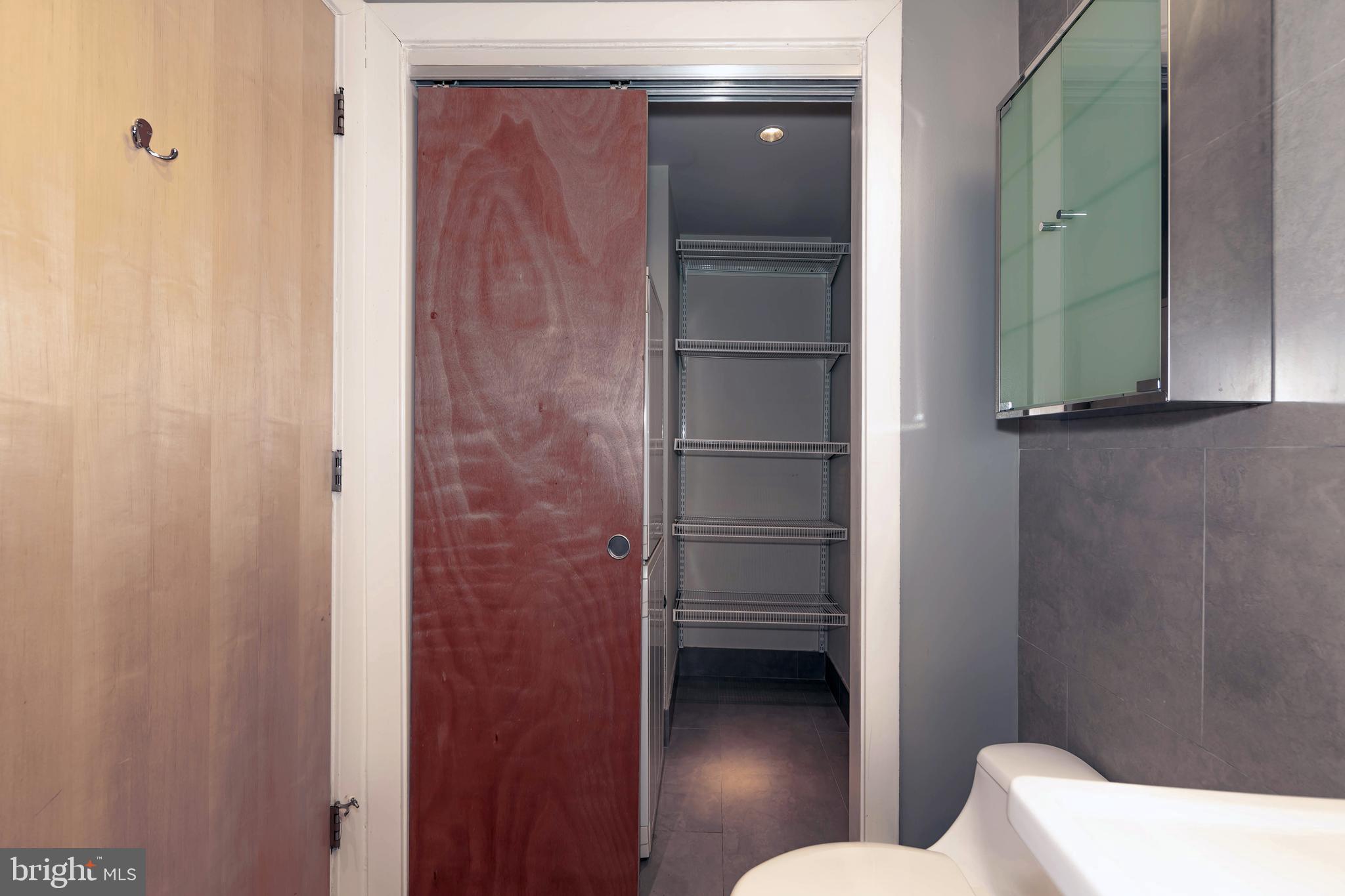 1133 14th Street Northwest, Unit 1109 Washington, DC 20005 - Photo 17 of 25 Deep Storage beside Washer/Dryer