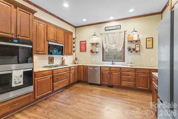 a large kitchen with stainless steel appliances lots of counter top space