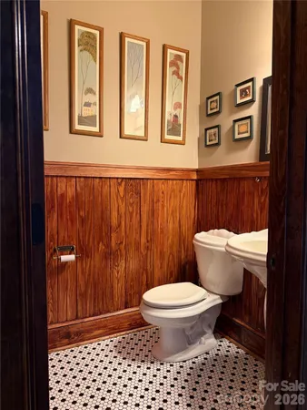 a bathroom with a toilet and a shower curtain