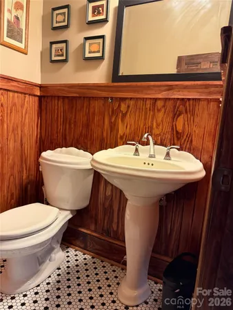 a bathroom with a toilet a sink and a mirror