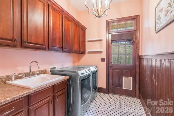 a kitchen with a sink cabinets and appliances