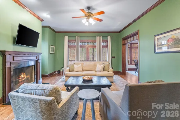 a living room with furniture a flat screen tv and a fireplace