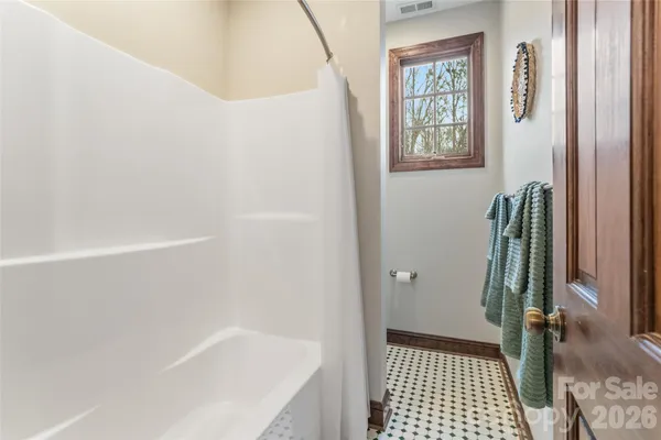 a bedroom with a large bed and a book shelf