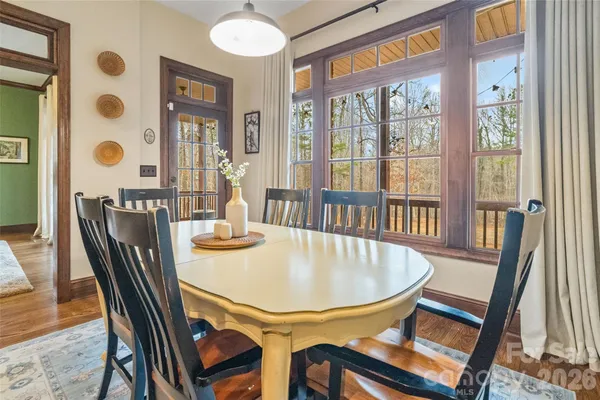 a dining room with furniture a rug and wooden floor