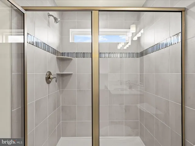 a bathroom with a glass shower door