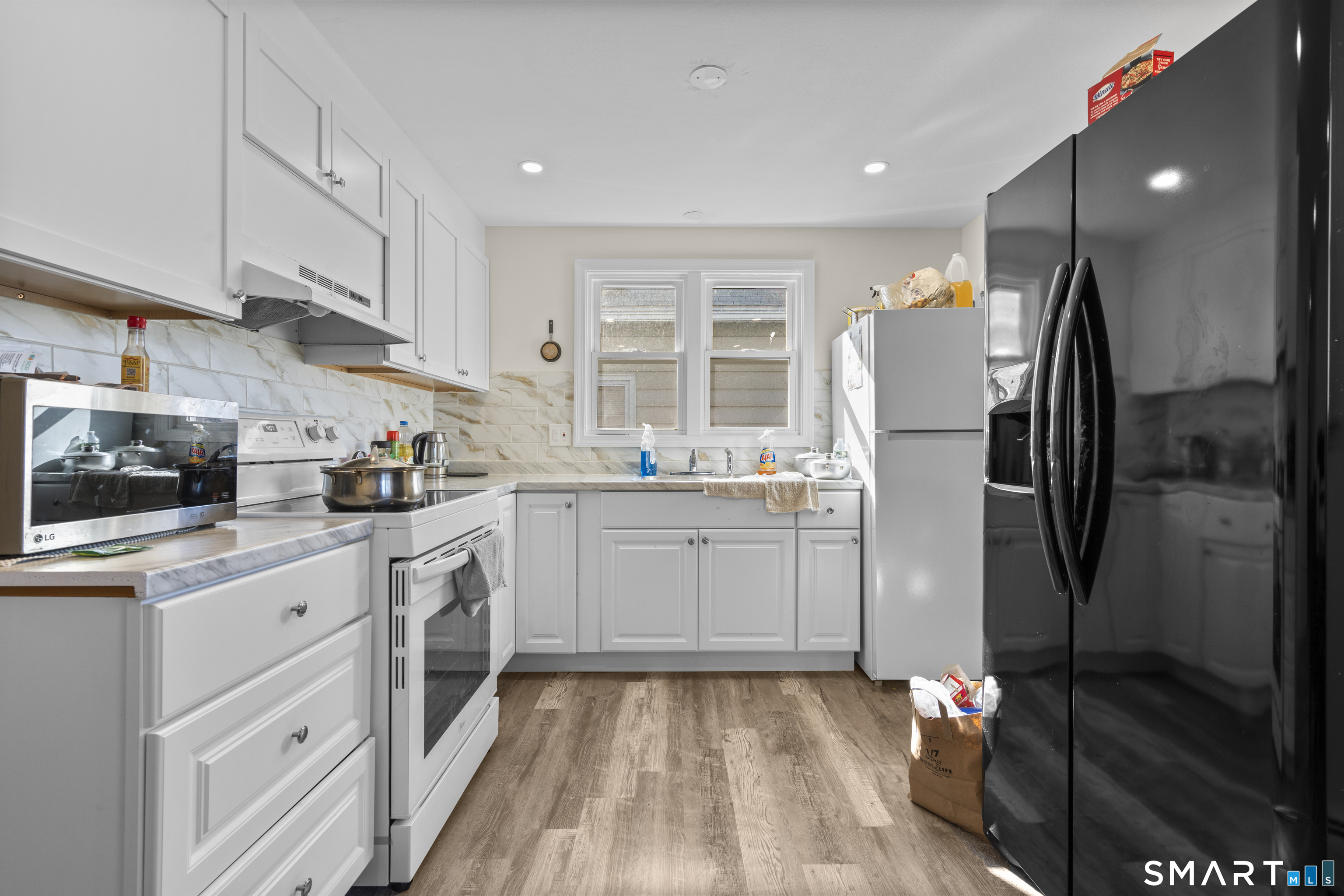 49-51 3rd Street Hamden, CT 06514 - Photo 17 of 40 a kitchen with a refrigerator sink and cabinets