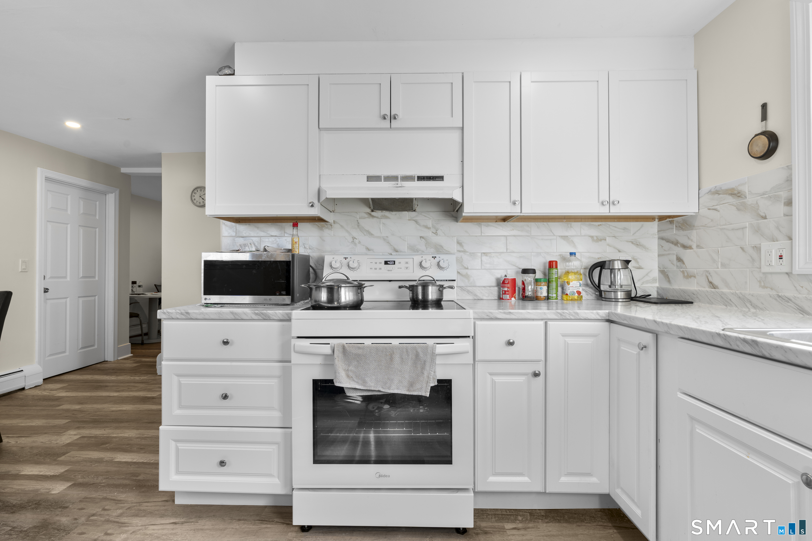 49-51 3rd Street Hamden, CT 06514 - Photo 18 of 40 a kitchen with white cabinets and white appliances
