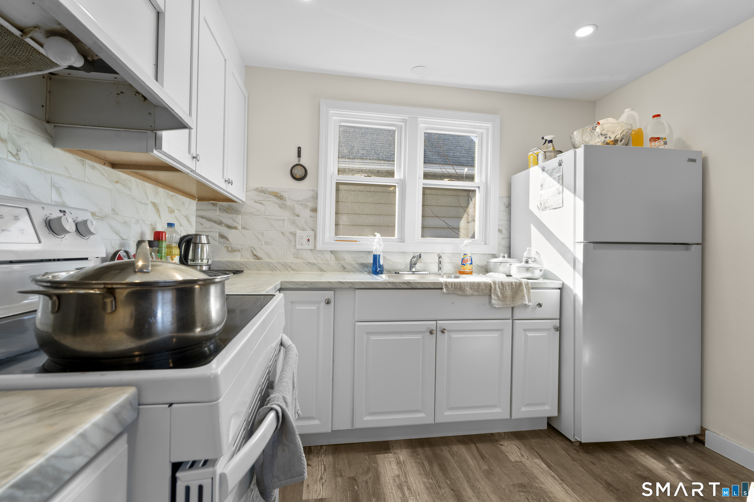 49-51 3rd Street Hamden, CT 06514 - Photo 20 of 40 a kitchen with stainless steel appliances granite countertop a sink a stove and a refrigerator