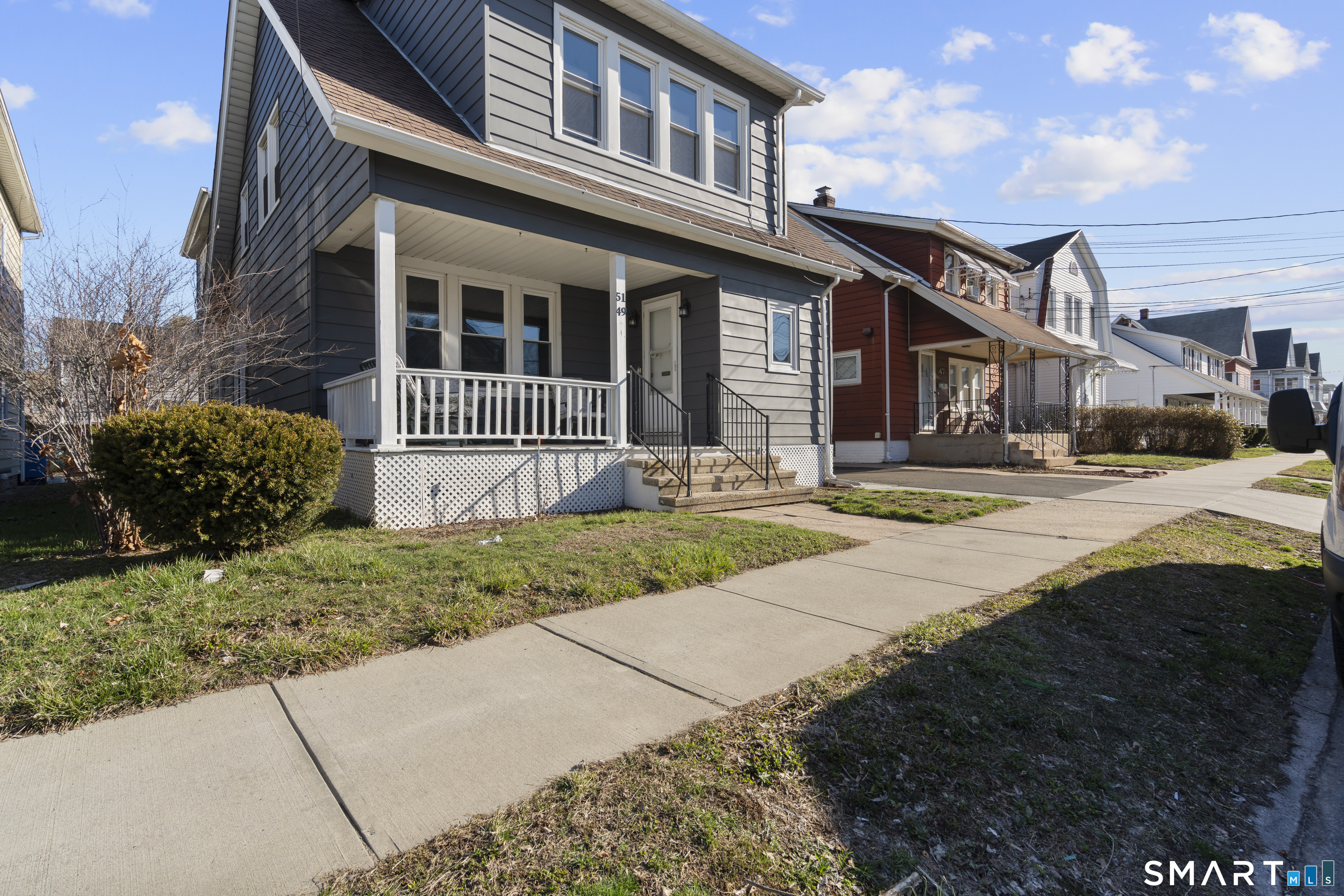 49-51 3rd Street Hamden, CT 06514 - Photo 2 of 40 a front view of a house with a yard and potted plants