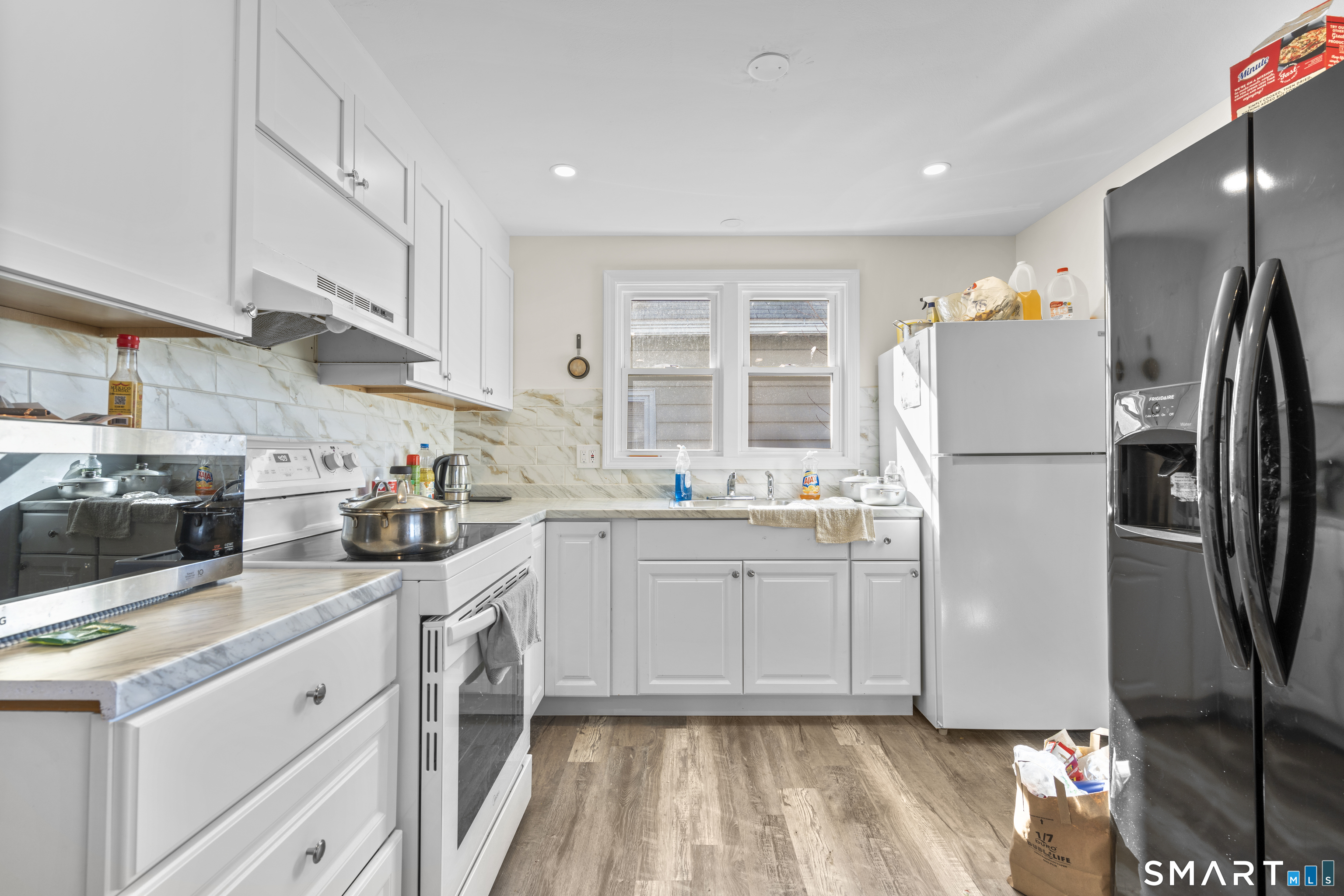 49-51 3rd Street Hamden, CT 06514 - Photo 22 of 40 a kitchen with a refrigerator sink and cabinets