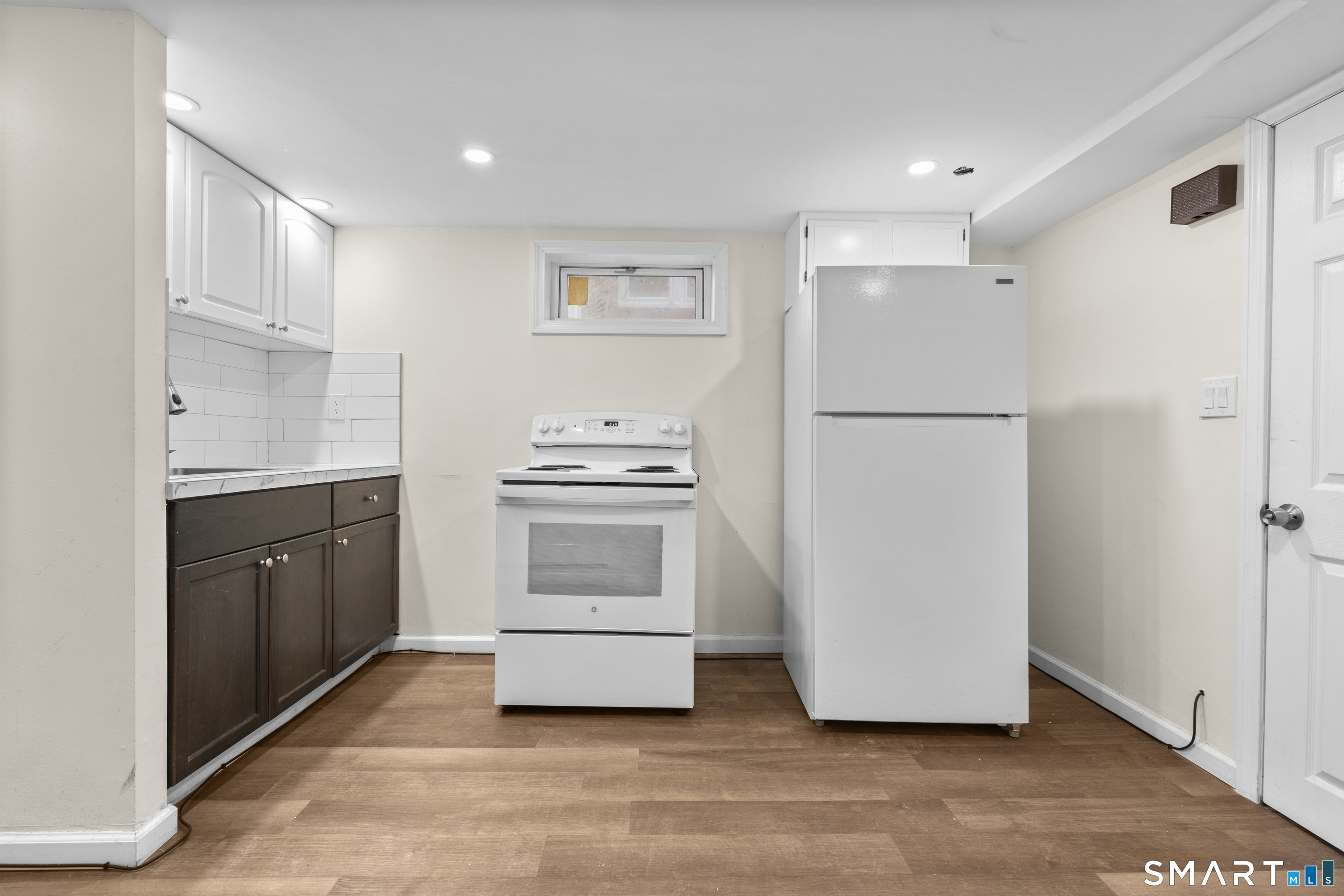 49-51 3rd Street Hamden, CT 06514 - Photo 28 of 40 a kitchen with sink a white refrigerator and white cabinets