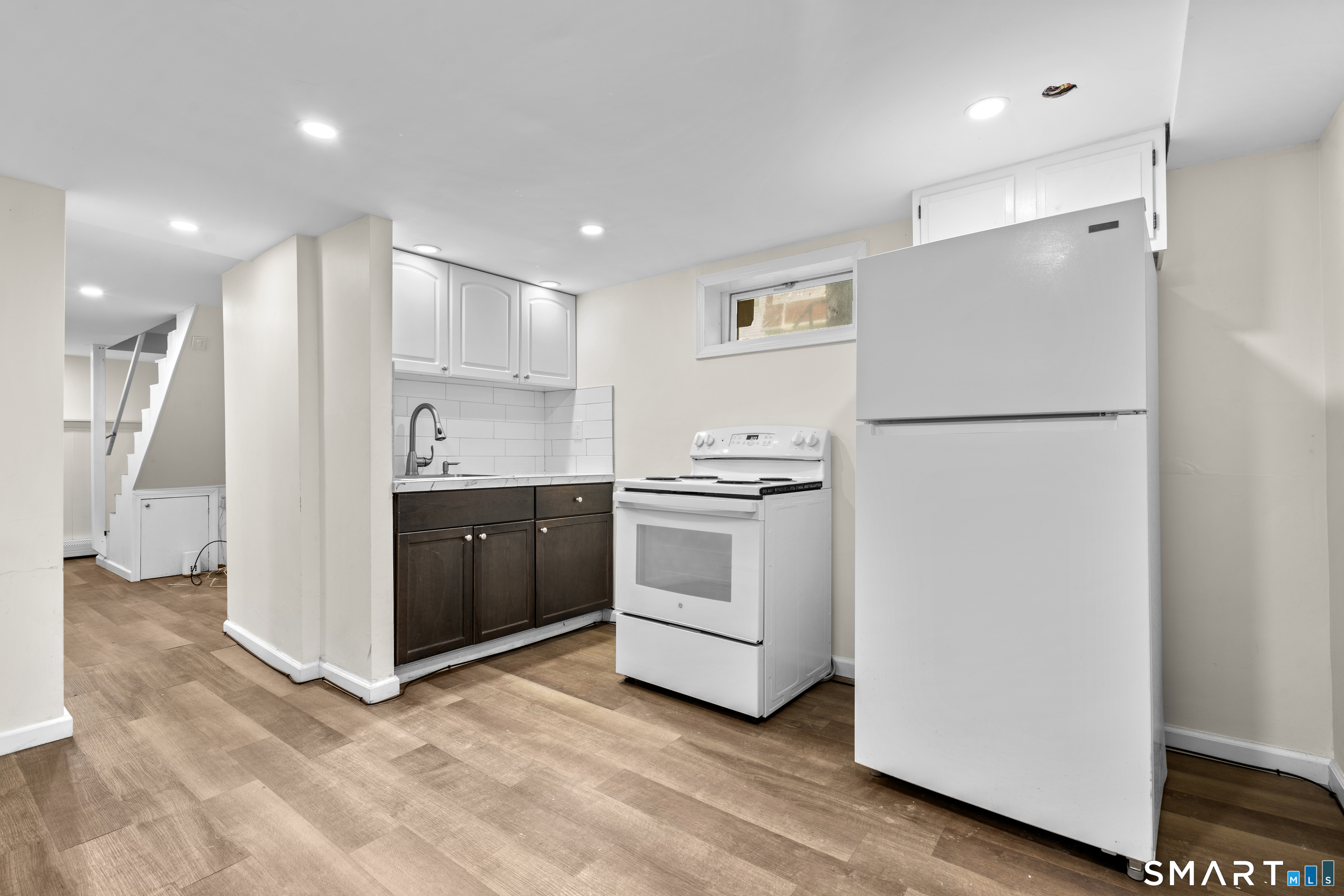 49-51 3rd Street Hamden, CT 06514 - Photo 30 of 40 a kitchen with white cabinets and white appliances
