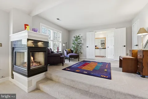 a bedroom with furniture and a rug