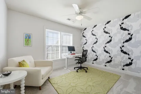 a view of a livingroom with an empty space and a hallway